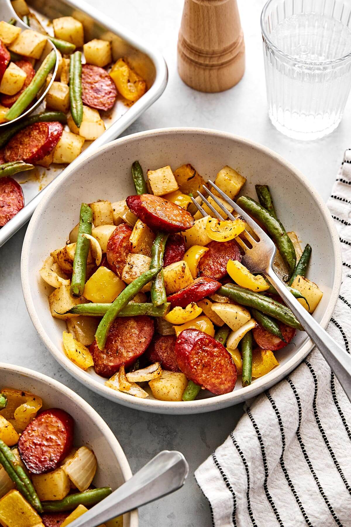 A bowl of Cajun sausage and vegetables.